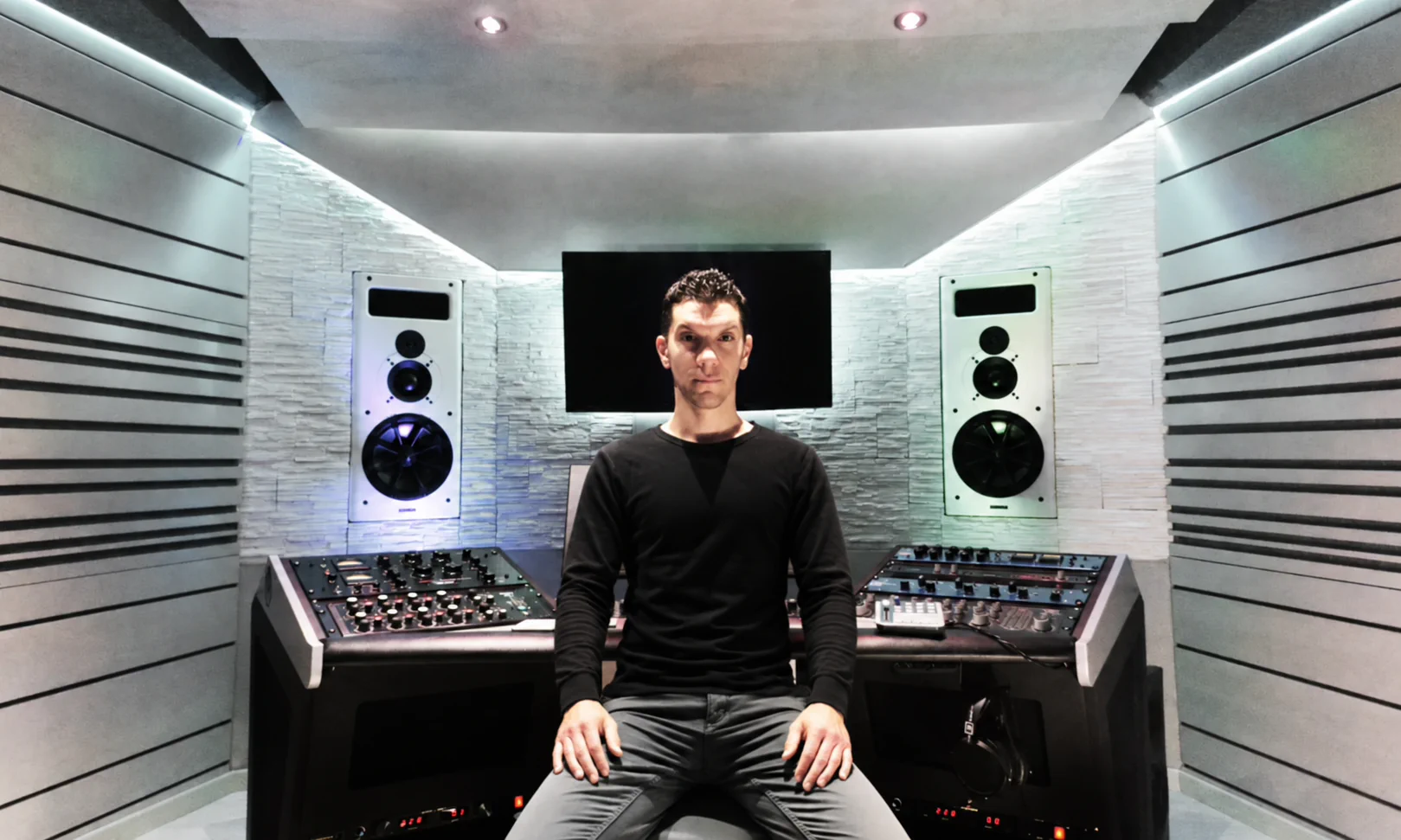 Carlo Camera, de brazos cruzados, sentado en el centro de la consola de Solid Mastering.